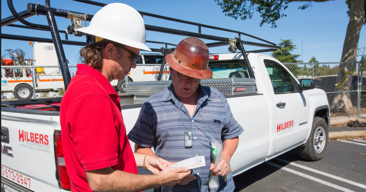 Hilbers Construction workers effectively communicating and updating clients.