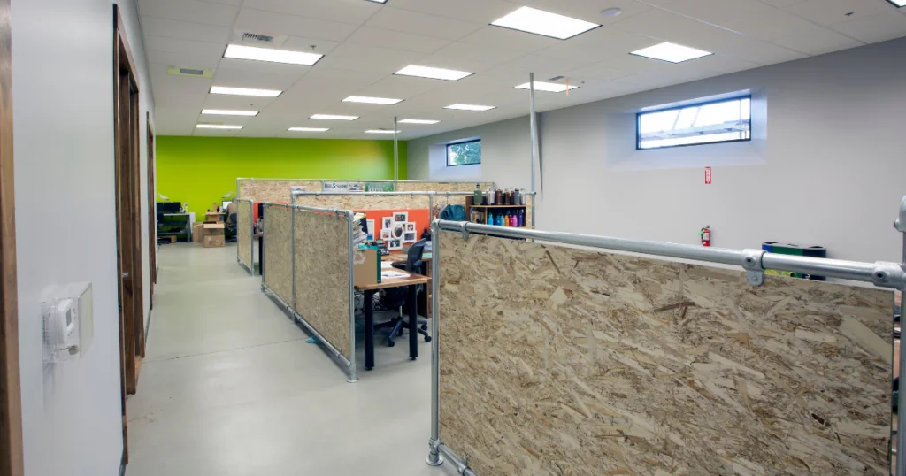 The Kleen Kanteen office has four dividers built with recycled plywood for sustainability. The back wall of the office is bright green.