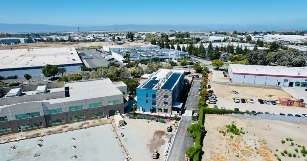 The California Crosspoint Academy New Education Building built with energy-efficient designs, including solar panels. It is an ariel shot of the numerous buildings in the complex.
