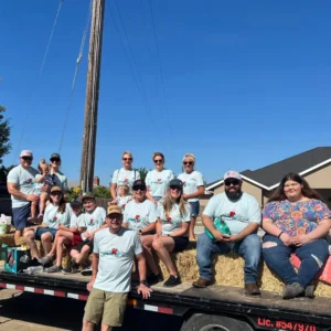 Hilbers employees sitting on a trailer .