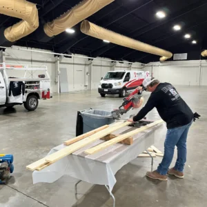 A man cutting boards with a circular saw.