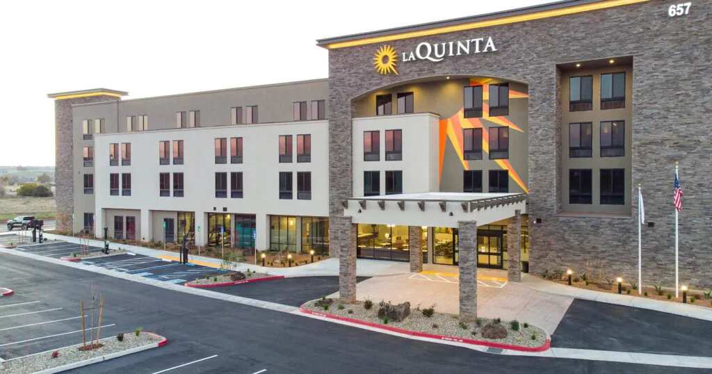 Completed hotel rebuild project showing a fully renovated exterior with modern design, upgraded systems, and improved guest accessibility after a complete commercial building reconstruction