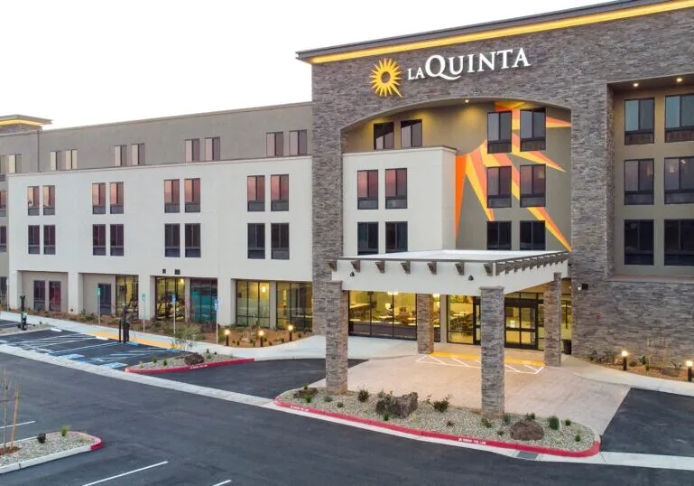 Completed hotel rebuild project showing a fully renovated exterior with modern design, upgraded systems, and improved guest accessibility after a complete commercial building reconstruction